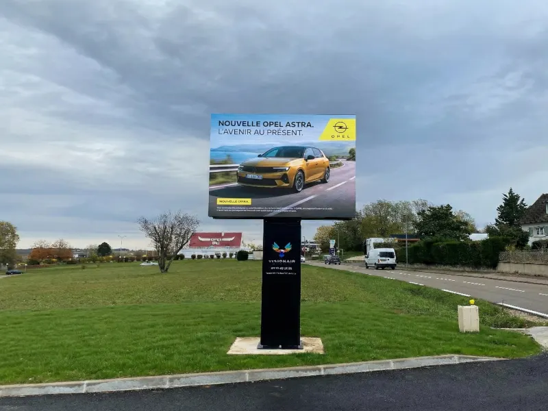Panneau LED publicitaire numérique en centre-ville sur trottoir